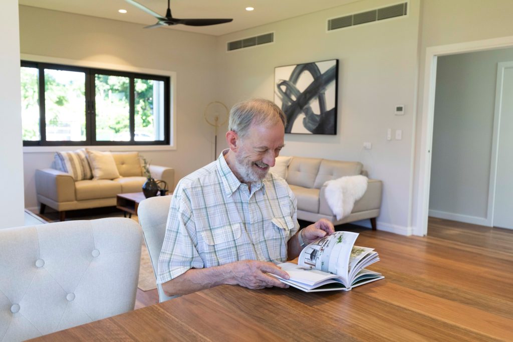 Sustainable-and-eco-friendly-Sherwood-home-by-dion-Deminara-architecture-owner-reading-a-book
