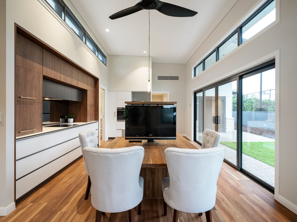 Sustainable-and-eco-friendly-Sherwood-home-by-dion-Deminara-architecture-kitchen-or-conference-area-with-popup-television