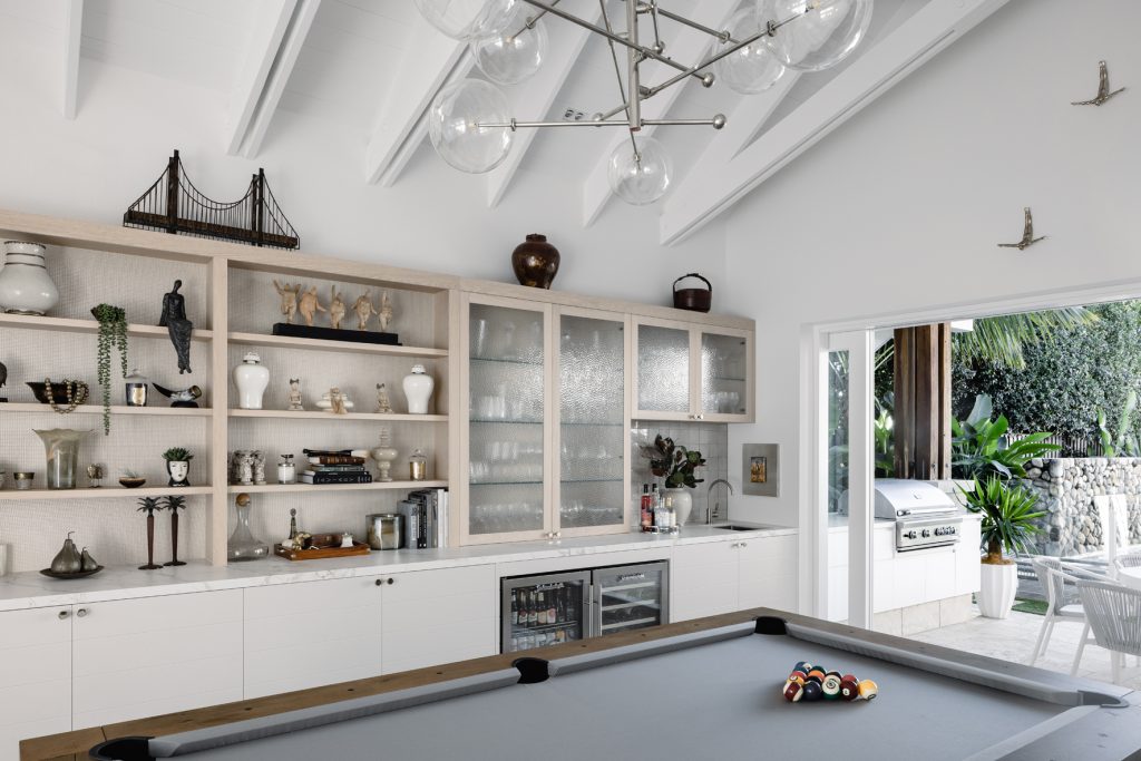 Darren-james-interiors-gold-coast-home-sports-room-with-pool-table-and-display-shelves-open-to-outside
