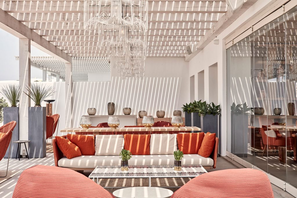 Naia Mykonos - outdoor lounge area by the pool